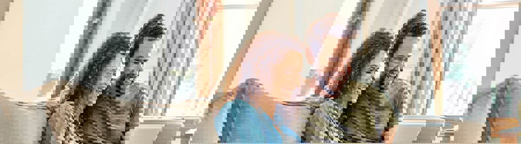 Couple on couch with tablet